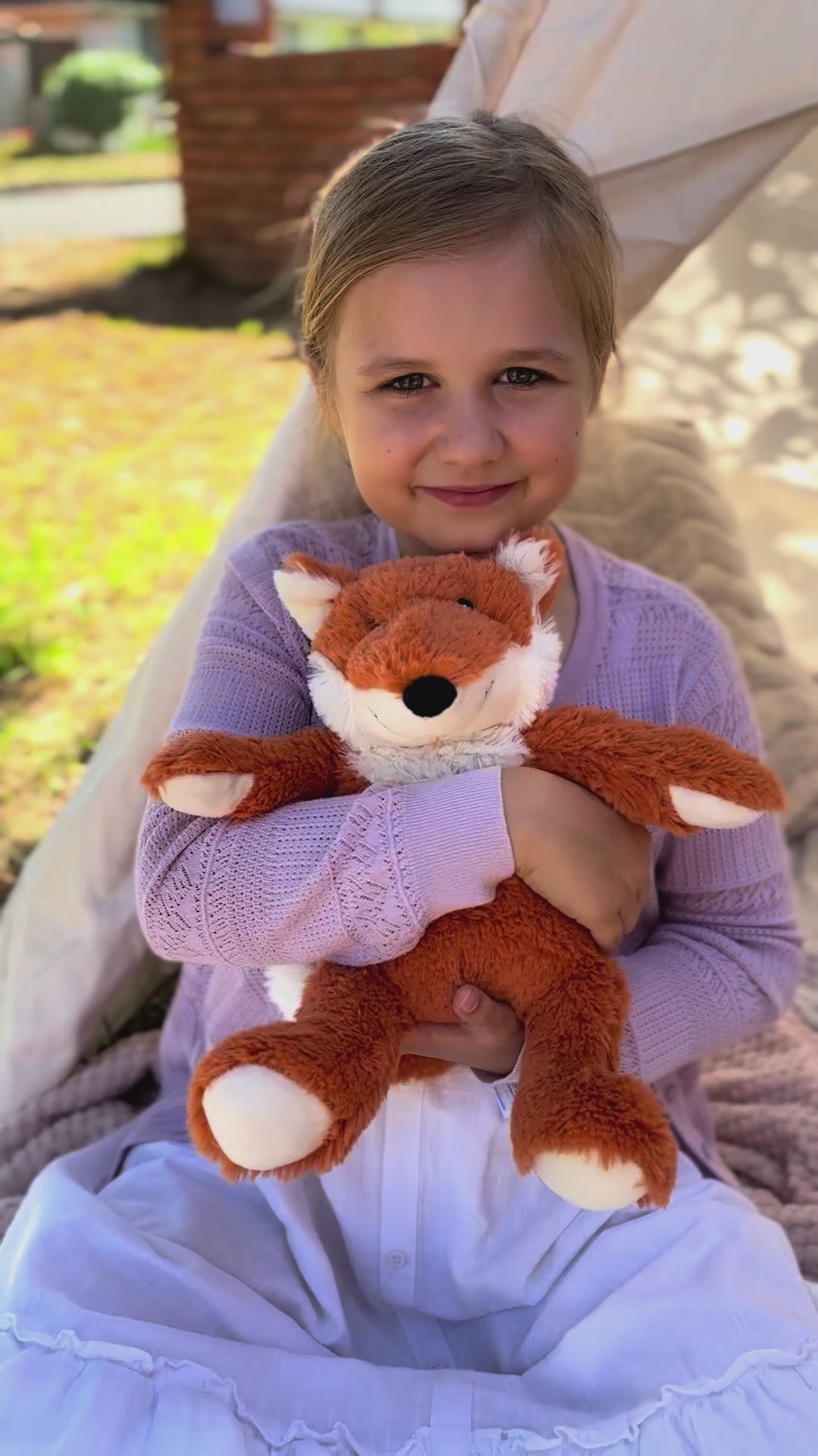 Girl holding Fox plushie - Warmies brand - weighted, lavender scented heat bag video