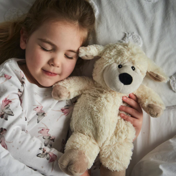 Girl hugging Warmies Sheep Heatbag Plushie