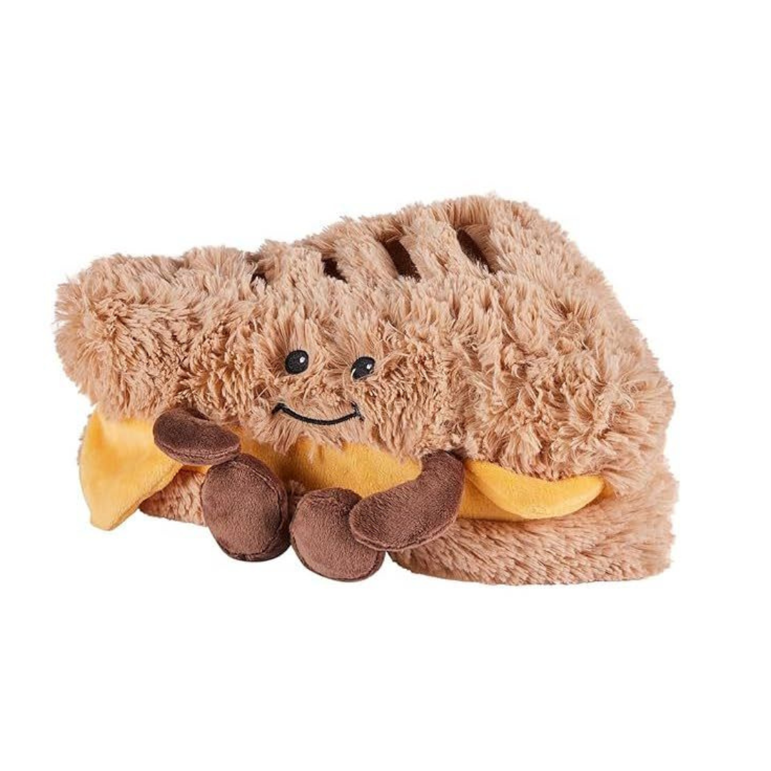 Plush toy resembling a hot dog with a face on a white background