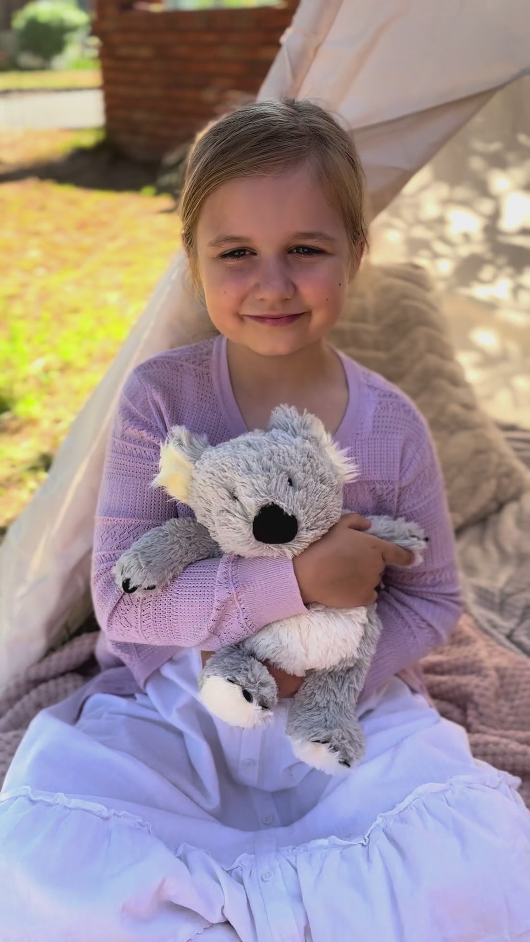 Girl holding Koala plushie - Warmies brand - weighted, lavender scented heat bag video